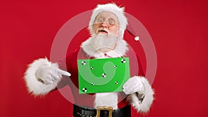 Santa Claus Shows an Approving Thumbs-up Gesture With Space for Text or Advertising on Red. Cheerful Santa Claus Holding
