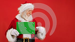 Santa Claus Shows an Approving Thumbs-up Gesture With Space for Text or Advertising on Red. Cheerful Santa Claus Holding