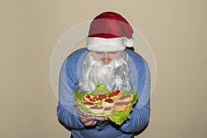 Santa Claus shows a lot of sandwiches with red caviar.