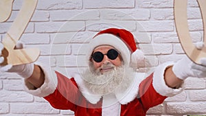 Santa Claus singing carols with wooden numbers in hands