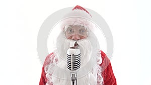 Santa Claus sings to retro vintage microphone christmas song. Santa is singing to classic microphone on white background