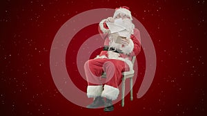 Santa Claus sitting on chair with letters in hands on red background with snow
