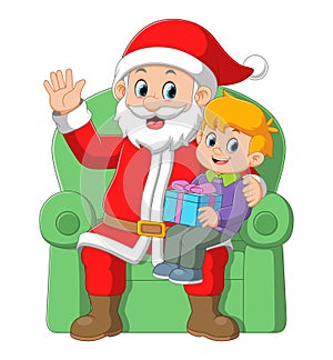 Santa claus sitting in chair with a little cute boy