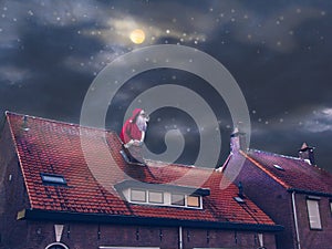 Santa Claus sitting in a chimney on a roof in the night. Merry Christmas and happy holidays! Mixed media