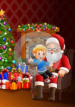 Santa Claus sitting with a little cute boy over Christmas background