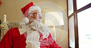 Santa claus sitting and looking through window