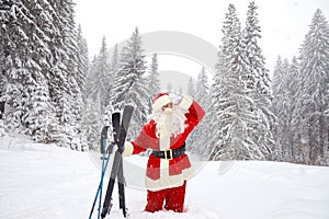 Santa Claus skier with skis in the woods in winter at Christmas.