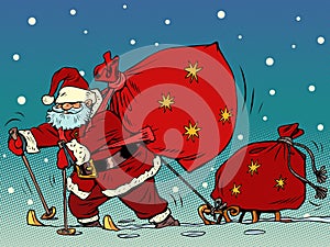 Santa Claus is skiing in the snow with a sled and gifts. Christmas and New Year. Winter seasonal holiday