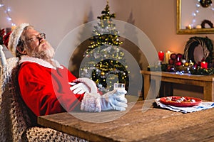 Santa Claus sleeping on chair