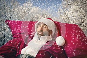 Santa Claus sleeping in the snow