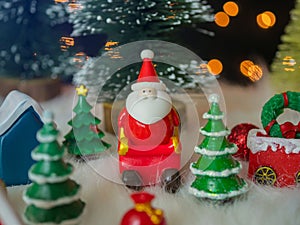 Santa claus on sleigh and christmas trees and other decorates with bokeh lights