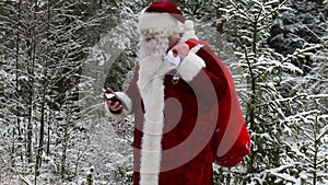 Santa Claus with smarphone in woods