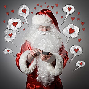 Santa Claus and smart phone. Love concept.