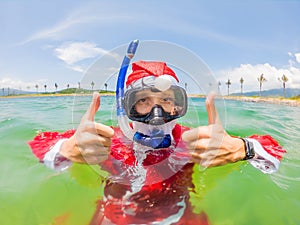 Santa claus is snorkeling underwater - christmas or happy new year concept. Christmas in the tropics after quarantine