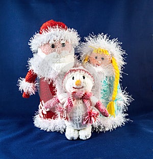 Santa Claus with snow Maiden and snowman. Knitting simbol