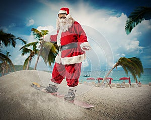 Santa Claus with snowboard in a beach