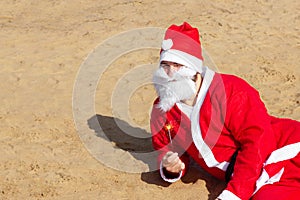 Santa Claus with sparkler on the beach