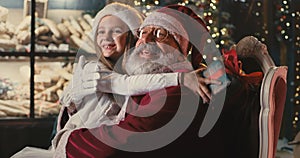 Santa Claus speaking with girl on Christmas eve