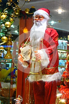 Santa Claus or St. Nicholas in festive decorated window, traditional decoration christmas house on New Year's Eve