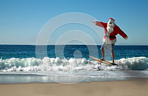 Santa Claus surfing in the ocean