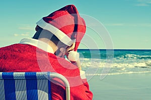 Santa claus taking a nap on the beach