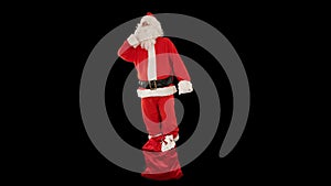Santa Claus talking on mobile phone with bag filled with presents at his feet, Alpha Channel