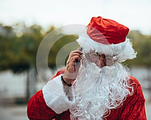 Santa claus talking to a mobile phone