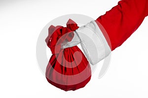 Santa Claus theme: Santa holding a big red sack with gifts on a white background