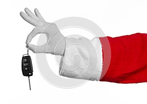 Santa Claus theme: Santa's hand holding the keys to a new car on a white background