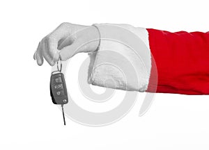 Santa Claus theme: Santa's hand holding the keys to a new car on a white background