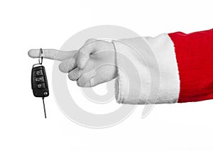 Santa Claus theme: Santa's hand holding the keys to a new car on a white background