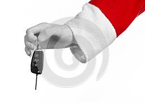 Santa Claus theme: Santa's hand holding the keys to a new car on a white background