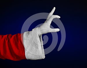 Santa Claus theme: Santa's hand showing gesture on a dark blue background