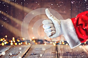 Santa Claus thumb up gesture over Christmas background