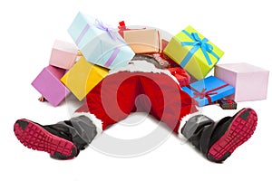 Santa claus too tired to lie on floor with many gift boxes