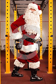 Santa Claus training before Christmas in gym - kettlebells