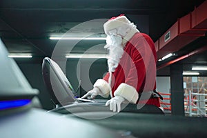 Santa Claus training at the gym on Christmas Day. Santa Claus running in machine treadmill at fitness gym club.