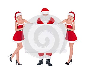 Santa Claus and two happy cute Snow Maiden women with christmas