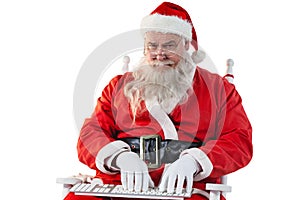 Santa claus typing keyboard against white background