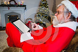 Santa Claus using digital tablet