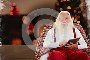Santa claus using digital tablet at home