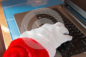 Santa Claus using laptop and typing the keyboard