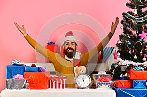 Santa Claus waits for New Year near decorated tree