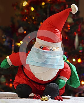 Santa Claus wearing a blue surgical mask
