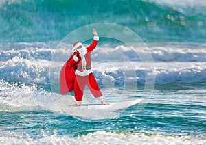 Santa Claus windsurfer with gifts sack surfing at ocean waves