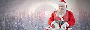 Santa Claus in Winter typing on laptop