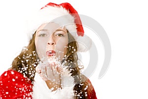 Santa Claus woman is blowing Christmas snow