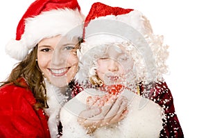 Santa Claus Woman and child blowing Christmas snow