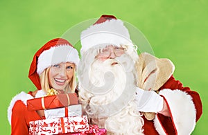 Santa claus, woman and hug for Christmas gift in studio holiday celebration, box giving and festive vacation. Old man