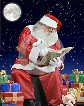 Santa Claus writing his notebook on the roof of a